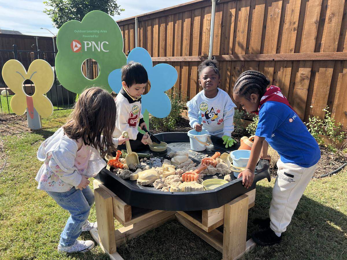 A group of 3- and 4-year-old students play with sand and water at a sensory table in the outdoor learning area of the Child Care Studio at Rise in Fort Worth’s Las Vegas Trail Neighborhood on May 7, 2026.